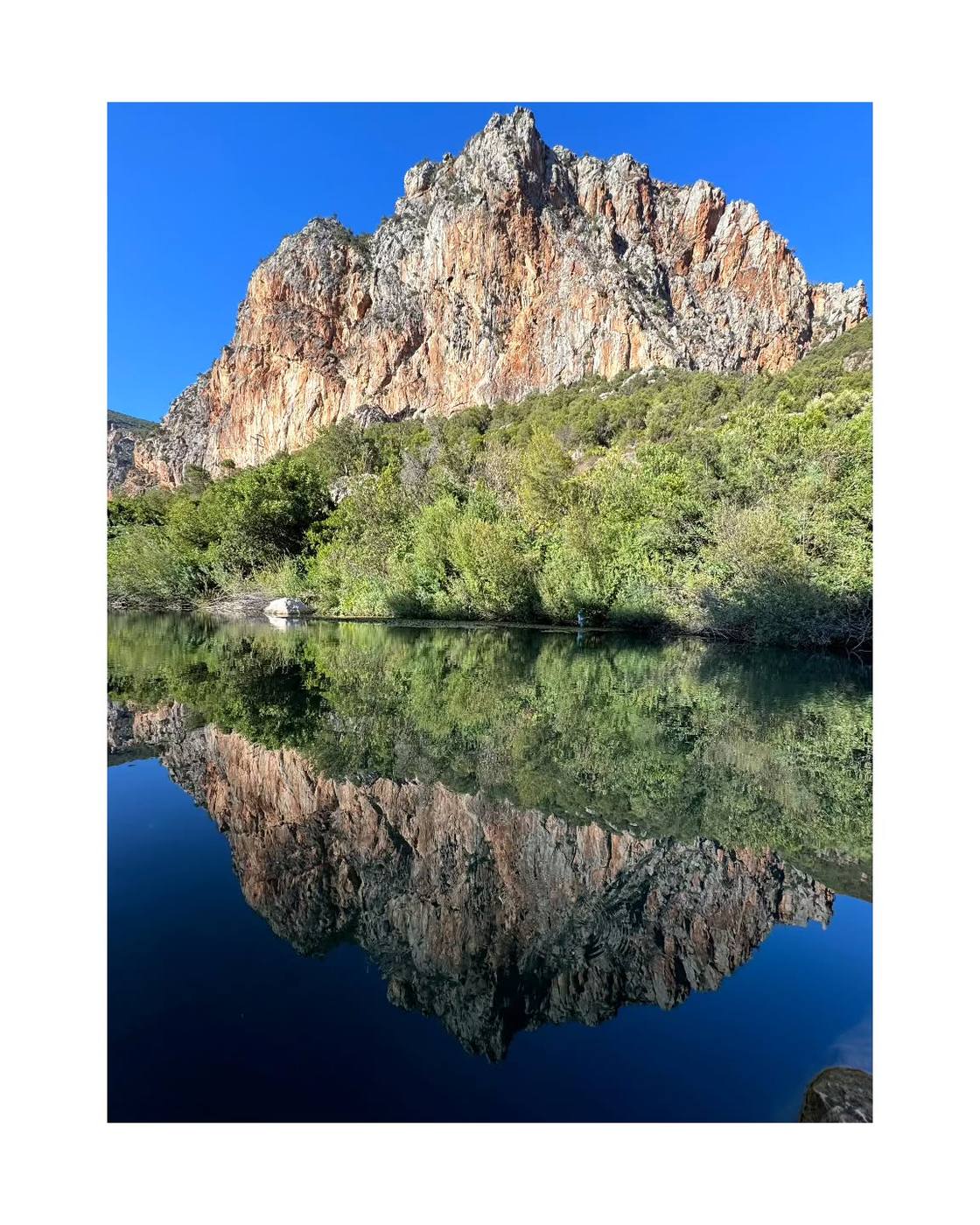 Rif Mountains reflected in a still lake, Northern Morocco
